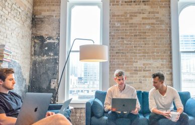 three men using MacBooks