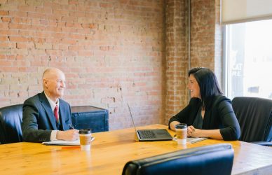 man and woman talking inside office
