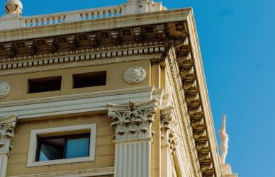 A tall building with statues on top of it